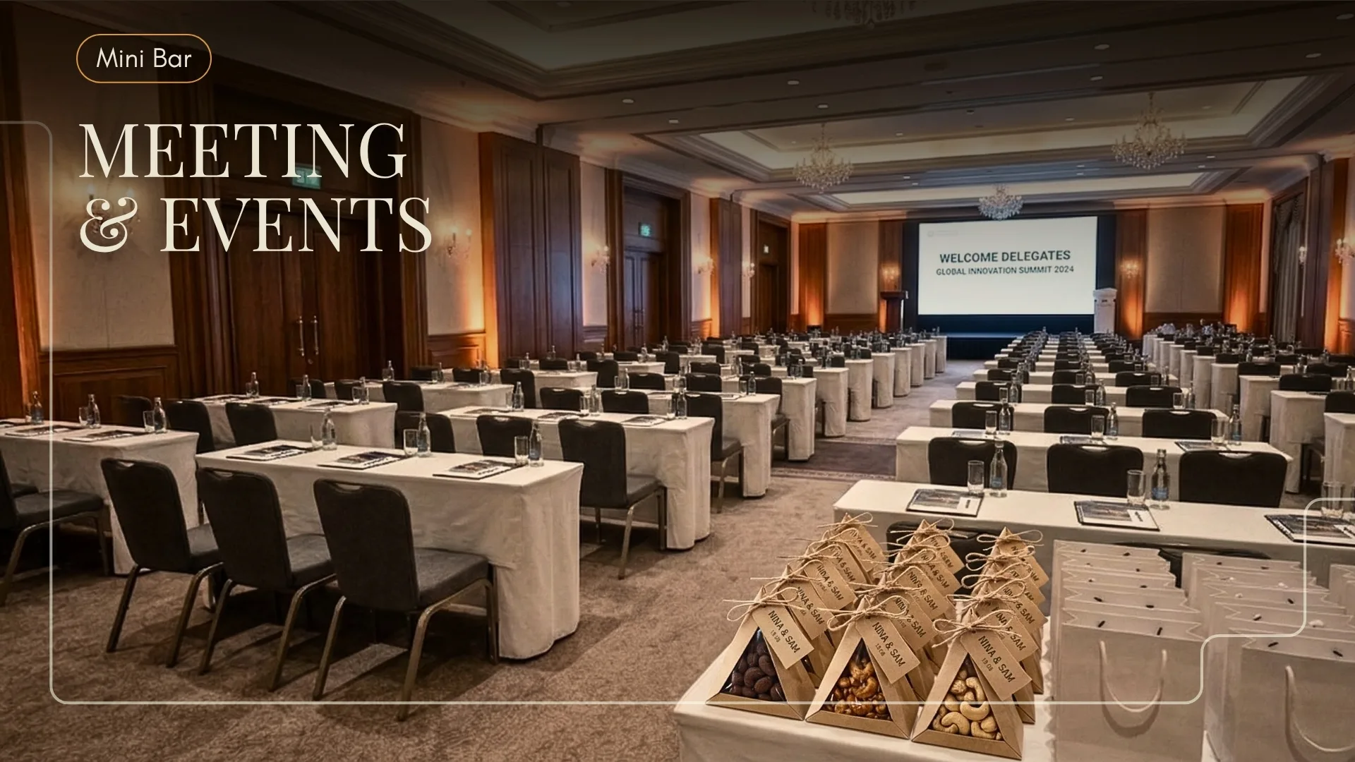 Conference ballroom set for delegates with branded cashew cones on a welcome table