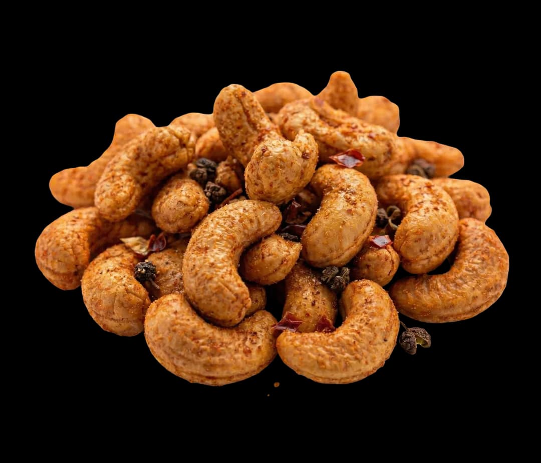 Mala-flavoured cashews on a white background